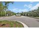 Community entrance with a decorative sign and lush landscaping at 6254 Woodhaven Village Dr, Port Orange, FL 32128