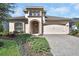Charming home showcasing a well-manicured lawn and a two-car garage at 6254 Woodhaven Village Dr, Port Orange, FL 32128