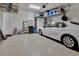 Spacious garage with storage shelves, a car parked inside, and ample room for parking at 6254 Woodhaven Village Dr, Port Orange, FL 32128