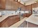 Spacious kitchen with stainless steel appliances, tile backsplash, and granite countertops at 6254 Woodhaven Village Dr, Port Orange, FL 32128