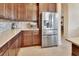 Bright kitchen with stainless steel refrigerator, matching appliances, and beautiful cabinets at 6254 Woodhaven Village Dr, Port Orange, FL 32128