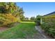 Lush backyard with mature trees and manicured lawn, offering a serene outdoor retreat at 701 N Tuxedo Ave, Deland, FL 32724