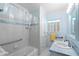 Bathroom featuring a tiled shower and tub with retro cabinets and hardware at 701 N Tuxedo Ave, Deland, FL 32724