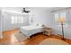 Bright bedroom with hardwood floors, ceiling fan, and plantation shutters at 701 N Tuxedo Ave, Deland, FL 32724