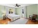 Bedroom with hardwood floors, neutral paint, ceiling fan, and great natural light at 701 N Tuxedo Ave, Deland, FL 32724
