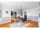 Bright dining room featuring hardwood floors, decorative lighting, and built-in cabinets at 701 N Tuxedo Ave, Deland, FL 32724