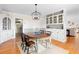 Dining room featuring hardwood floors, modern light fixture, and built-in cabinets at 701 N Tuxedo Ave, Deland, FL 32724