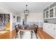 Formal dining room with hardwood floors, and white built-in china cabinet at 701 N Tuxedo Ave, Deland, FL 32724