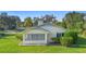 Well-maintained home showcasing lush landscaping, a manicured lawn, and classic architectural details at 701 N Tuxedo Ave, Deland, FL 32724