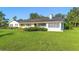 Charming single-story home with lush green lawn and mature landscaping at 701 N Tuxedo Ave, Deland, FL 32724