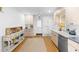 Kitchen featuring bright lighting, ample cabinets, countertops, and stainless steel appliances at 701 N Tuxedo Ave, Deland, FL 32724