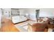 Inviting living room with hardwood floors, white sofa, and neutral decor at 701 N Tuxedo Ave, Deland, FL 32724