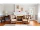 Cozy living room featuring hardwood floors, fireplace, and comfortable seating at 701 N Tuxedo Ave, Deland, FL 32724