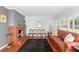Bright living room with fireplace, red tile flooring, comfortable seating, and natural light at 701 N Tuxedo Ave, Deland, FL 32724