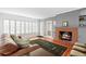 Cozy living room with brick fireplace, wood-look floors, and view to the exterior at 701 N Tuxedo Ave, Deland, FL 32724