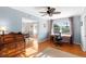 Bright home office with hardwood floors, and light blue paneled walls at 701 N Tuxedo Ave, Deland, FL 32724