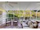 Sunroom with a ceiling fan, tile flooring, and many windows for natural light, and comfortable seating at 701 N Tuxedo Ave, Deland, FL 32724