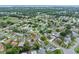 Expansive aerial view of a residential neighborhood with lush greenery and well-maintained homes at 718 Sleepy Hollow Dr, Port Orange, FL 32127