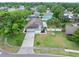 Aerial view of a home with a well-manicured lawn, palm trees, and an inviting arched entryway at 718 Sleepy Hollow Dr, Port Orange, FL 32127
