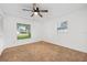 Bedroom featuring a window, ceiling fan, and carpet at 718 Sleepy Hollow Dr, Port Orange, FL 32127