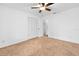 Bedroom features a ceiling fan, closet, and carpet at 718 Sleepy Hollow Dr, Port Orange, FL 32127