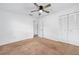 Bedroom featuring a closet, ceiling fan, and carpet at 718 Sleepy Hollow Dr, Port Orange, FL 32127