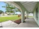 Exterior view from the covered front porch with brick arches, overlooking the green lawn and neighborhood street at 718 Sleepy Hollow Dr, Port Orange, FL 32127