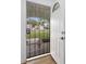 Entryway featuring a secure wrought iron security door and a white front door with decorative glass insert at 718 Sleepy Hollow Dr, Port Orange, FL 32127