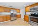 Bright kitchen with tile floors, stainless steel appliances, and wooden cabinets at 718 Sleepy Hollow Dr, Port Orange, FL 32127