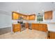 Well-lit kitchen with stainless steel appliances, warm wooden cabinets, and modern countertops at 718 Sleepy Hollow Dr, Port Orange, FL 32127