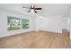 Spacious living room with modern vinyl flooring, ceiling fan, and ample natural light from a large window at 718 Sleepy Hollow Dr, Port Orange, FL 32127