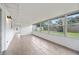 Bright sunroom with tile flooring and large windows overlooking the backyard and landscaping at 718 Sleepy Hollow Dr, Port Orange, FL 32127