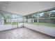 Sunroom with ample natural light from surrounding windows, showcasing the yard's greenery at 718 Sleepy Hollow Dr, Port Orange, FL 32127