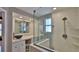 Modern bathroom featuring vessel sink, quartz countertops, and glass shower enclosure with window at 8 Ocean Dunes Dr, Ormond Beach, FL 32176