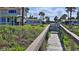 Private beach access, wooden walkway leading from the backyard to the sandy shore at 8 Ocean Dunes Dr, Ormond Beach, FL 32176