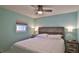 Cozy bedroom with a queen bed, ceiling fan, and neutral decor at 8 Ocean Dunes Dr, Ormond Beach, FL 32176