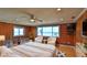 Bedroom with ocean view, light hardwood floors, a ceiling fan, and lots of natural light at 8 Ocean Dunes Dr, Ormond Beach, FL 32176