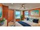 Bright bedroom with ocean views, hardwood floors, ceiling fan, and white trim at 8 Ocean Dunes Dr, Ormond Beach, FL 32176