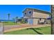 Beach home with a two-car garage, brick-paved driveway, grass lawn, and a covered outdoor entertainment area at 8 Ocean Dunes Dr, Ormond Beach, FL 32176
