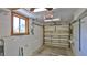 Spacious garage with window, ceiling fan and hanging utility rack at 8 Ocean Dunes Dr, Ormond Beach, FL 32176