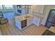 Modern kitchen with granite countertops, stainless steel appliances, and an island with built-in sink and dishwasher at 8 Ocean Dunes Dr, Ormond Beach, FL 32176