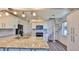 Modern kitchen with marble countertops, white cabinets, black appliances, and a spiral staircase to the upper level at 8 Ocean Dunes Dr, Ormond Beach, FL 32176