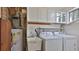 Laundry room with washer, dryer, utility sink, and white cabinets at 8 Ocean Dunes Dr, Ormond Beach, FL 32176