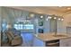 Bright living room featuring ocean views, a fireplace, and an open layout to the kitchen at 8 Ocean Dunes Dr, Ormond Beach, FL 32176