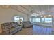 Bright living room featuring coastal views from the expansive windows and comfortable seating at 8 Ocean Dunes Dr, Ormond Beach, FL 32176