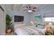 Bedroom showcasing coastal decor, a television, and a ceiling fan at 8 Ocean Dunes Dr, Ormond Beach, FL 32176