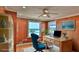Bright home office featuring a wooden desk, blue chair, and a window view of the ocean at 8 Ocean Dunes Dr, Ormond Beach, FL 32176