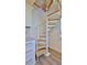 A spiral staircase featuring wooden treads and a white metal frame leads to an upper level of the home at 8 Ocean Dunes Dr, Ormond Beach, FL 32176
