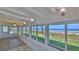 Bright sunroom featuring a wall of windows with stunning ocean views and modern lighting at 8 Ocean Dunes Dr, Ormond Beach, FL 32176