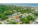 Aerial view of the property, showing the screened pool and nearby ocean at 809 E 14Th Ave, New Smyrna Beach, FL 32169